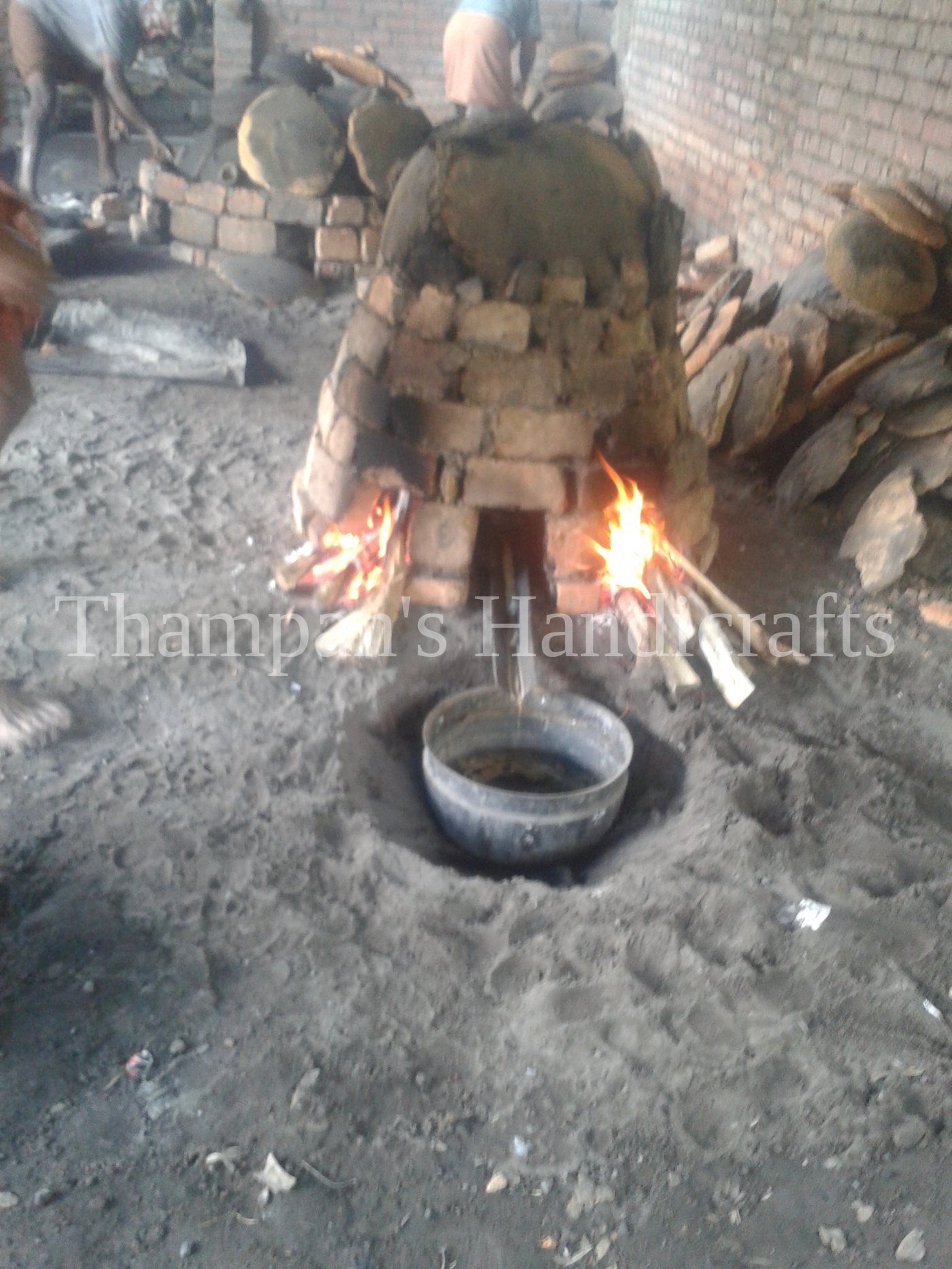 Dewaxing a church bell mould at the Mannar foundry